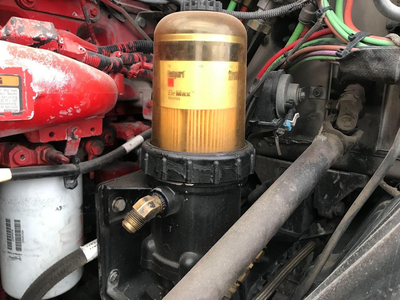 Mechanic performing a fuel system service for a fleet of trucks in Santa Barbara County